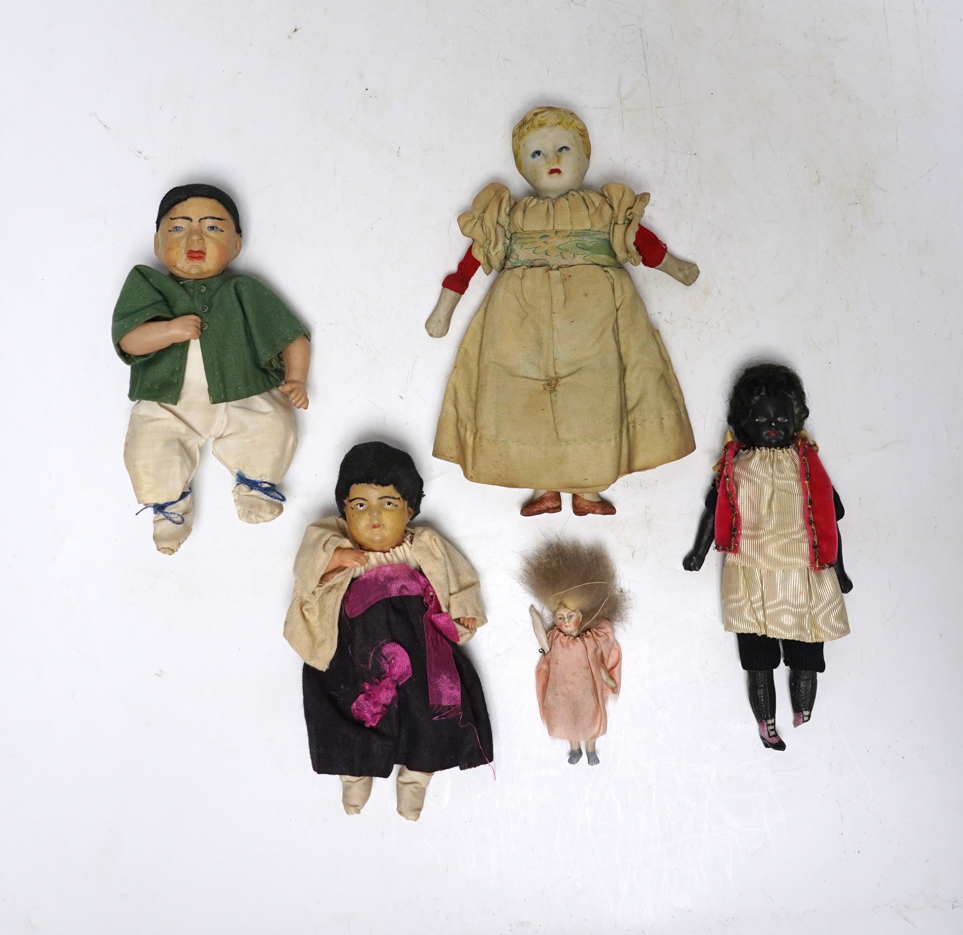 Five various small world dolls, two celluloid and three bisque/china, largest 15cm high